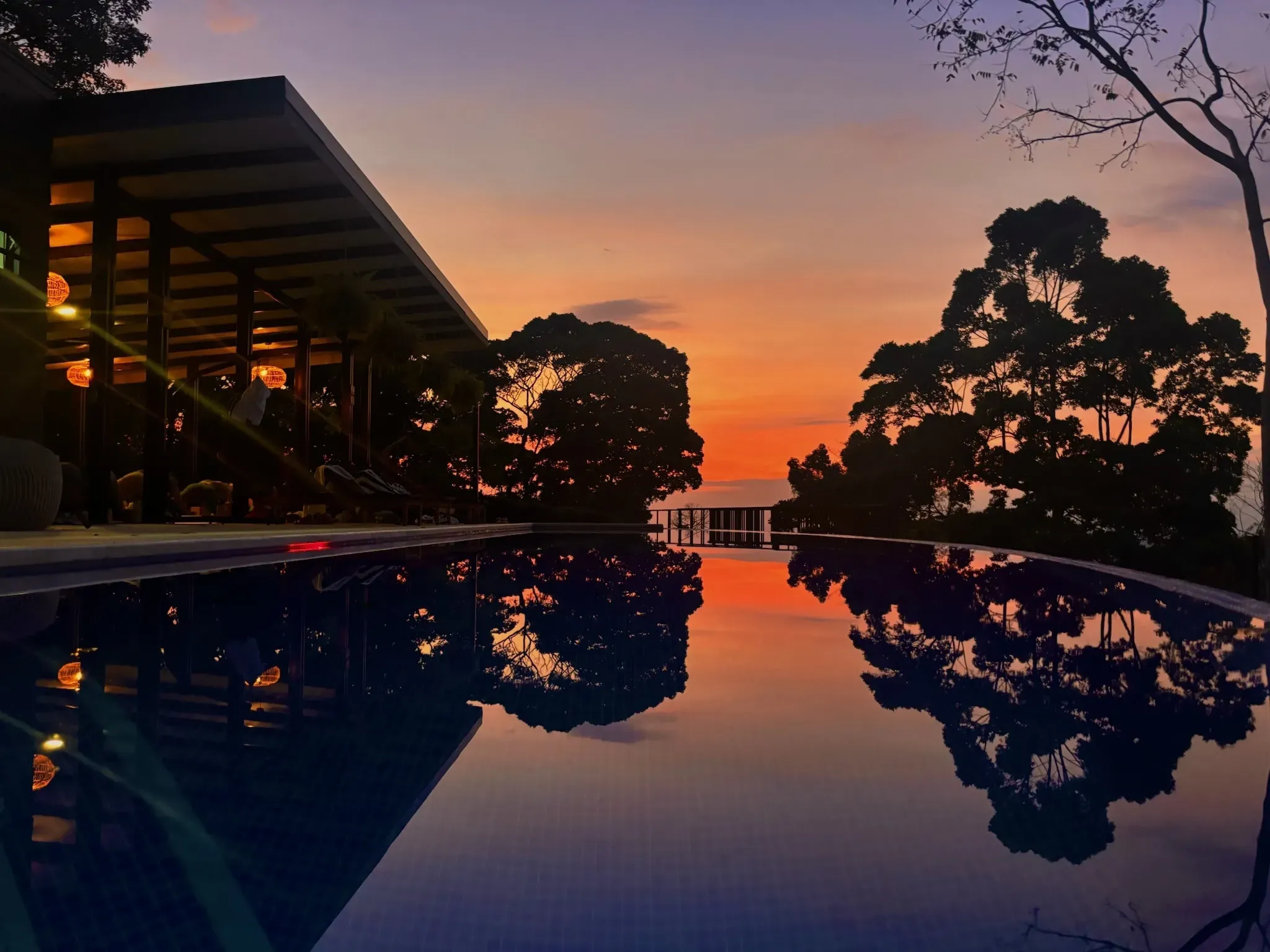 Sunset reflecting on the infinity pool at Vajra Jahra Retreat Center, creating a serene and picturesque atmosphere perfect for a retreat Costa Rica getaway.