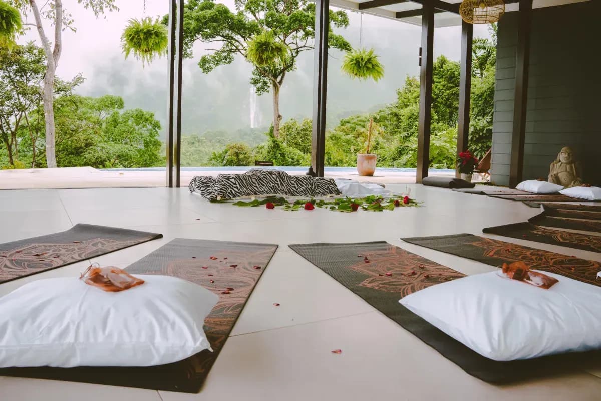 Yoga and meditation mats arranged at Vajra Jahra Retreat Center with views of the jungle and waterfalls, ready for a peaceful retreat Costa Rica session.